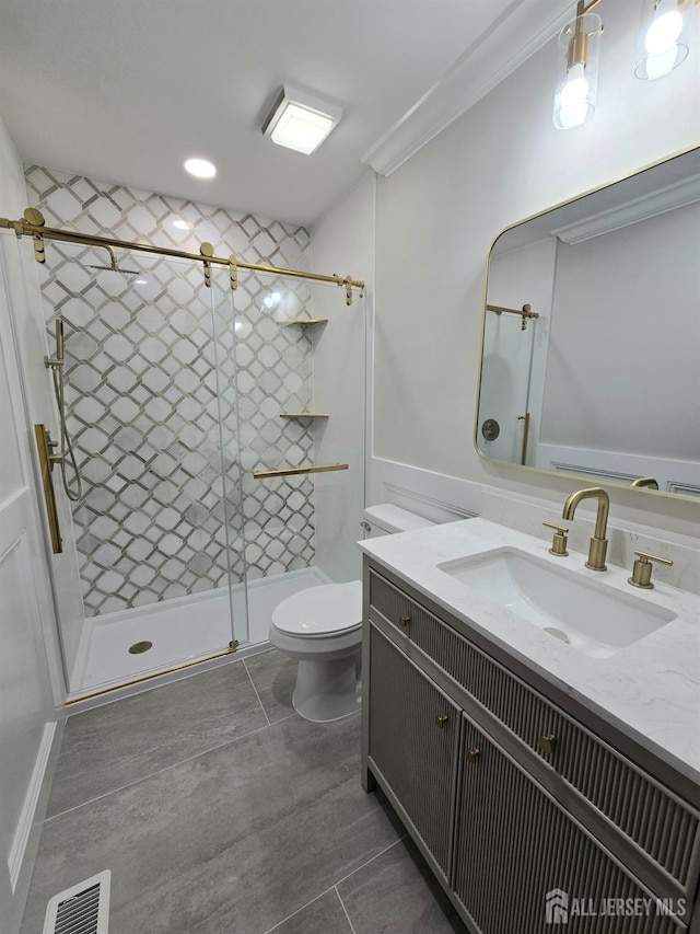 full bath featuring crown molding, vanity, toilet, visible vents, and a stall shower