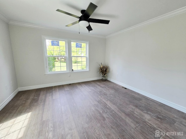 unfurnished room with dark wood-type flooring, baseboards, crown molding, and ceiling fan