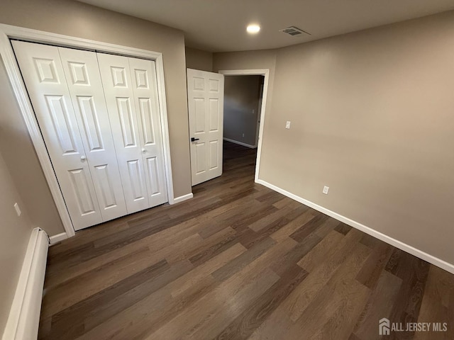 179 Buckelew Ave Unit A, Jamesburg, NJ 08831 - unfurnished bedroom featuring a baseboard heating unit, dark wood finished floors, recessed lighting, and a closet