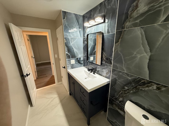 179 Buckelew Ave Unit A, Jamesburg, NJ 08831 - bathroom featuring marble look tiles, vanity, and tile walls