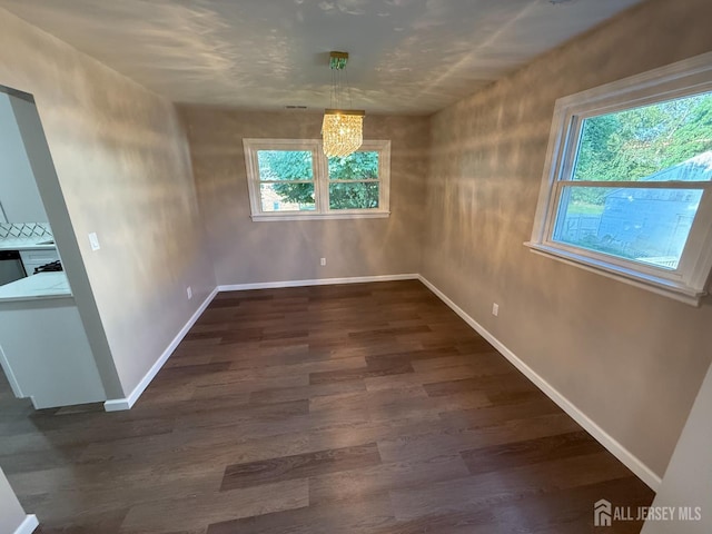 179 Buckelew Ave Unit A, Jamesburg, NJ 08831 - unfurnished dining area featuring dark wood-style flooring and a chandelier