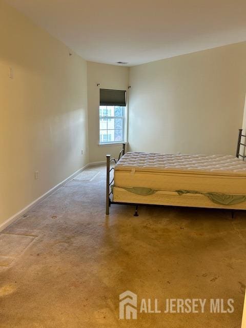 bedroom with baseboards and carpet flooring