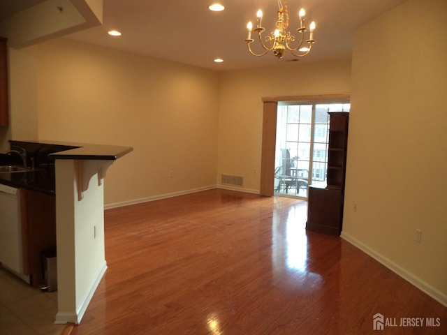 unfurnished dining area with baseboards, light wood finished floors, visible vents, and recessed lighting