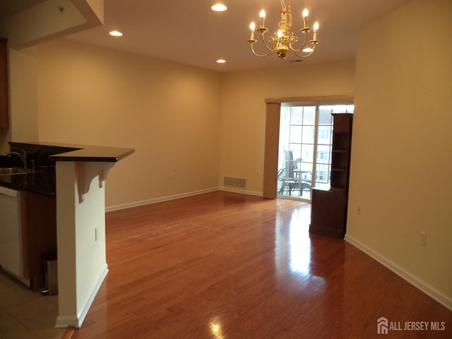 interior space with a notable chandelier, recessed lighting, baseboards, light wood-type flooring, and visible vents