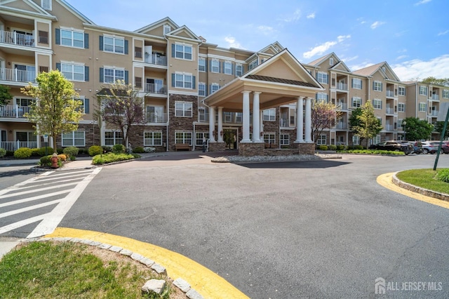 540 Cranbury Rd Unit 407, East Brunswick, NJ 08816 - view of building exterior featuring uncovered parking