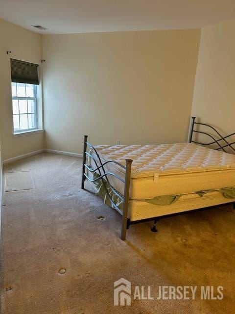bedroom with baseboards, carpet, and visible vents