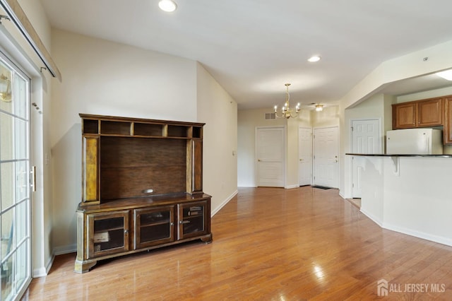540 Cranbury Rd Unit 407, East Brunswick, NJ 08816 - unfurnished living room featuring a notable chandelier, light wood-style flooring, recessed lighting, baseboards, and visible vents