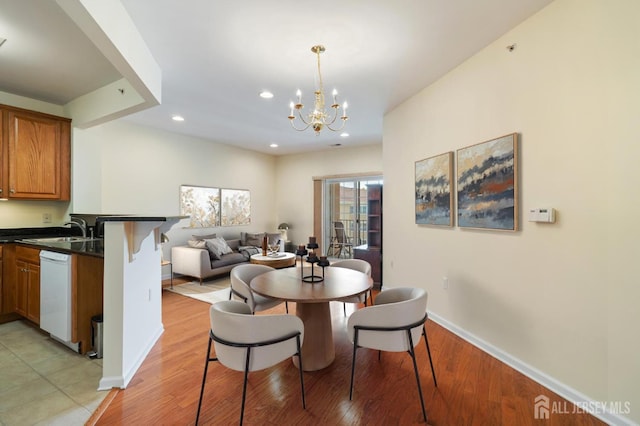 540 Cranbury Rd Unit 407, East Brunswick, NJ 08816 - dining area with an inviting chandelier, recessed lighting, light wood finished floors, and baseboards