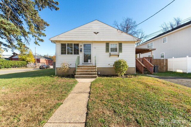 bungalow-style house featuring a front yard