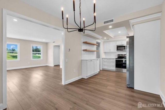 377-B Old Nassau Rd, Monroe, NJ 08831 - kitchen with stainless steel appliances, open shelves, white cabinetry, a chandelier, and open floor plan