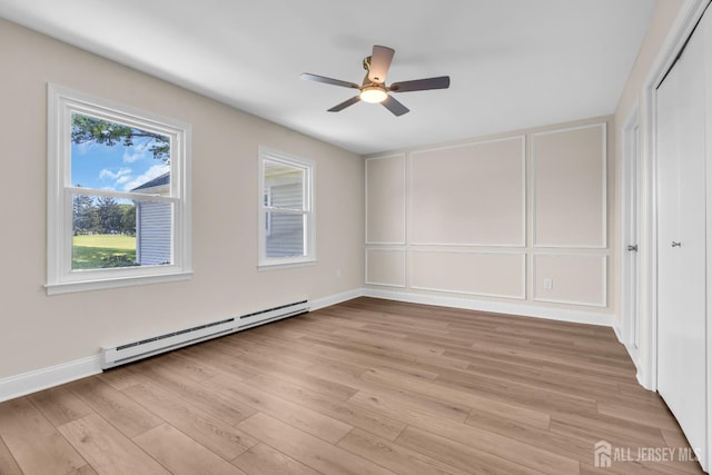 377-B Old Nassau Rd, Monroe, NJ 08831 - empty room with a baseboard radiator, a decorative wall, a ceiling fan, and light wood-style floors