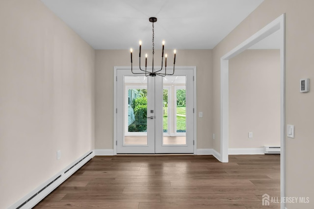 377-B Old Nassau Rd, Monroe, NJ 08831 - unfurnished dining area with a baseboard radiator, french doors, a chandelier, and wood finished floors