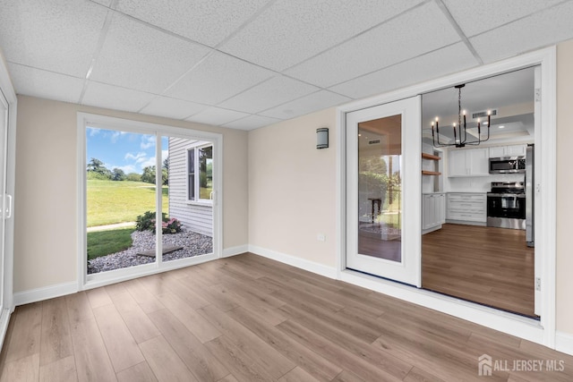 377-B Old Nassau Rd, Monroe, NJ 08831 - empty room with a drop ceiling, light wood-style floors, and a chandelier