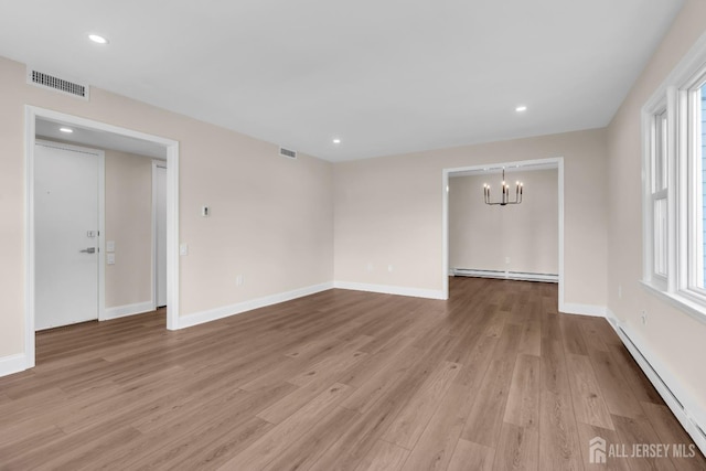 377-B Old Nassau Rd, Monroe, NJ 08831 - empty room featuring baseboard heating, a chandelier, wood finished floors, plenty of natural light, and recessed lighting