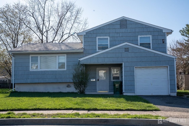1055 Rudyard Dr, Perth Amboy, NJ 08861 - tri-level home with a front lawn, asphalt driveway, and an attached garage