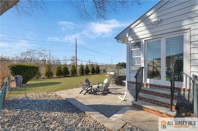 view of yard featuring a fire pit and a patio