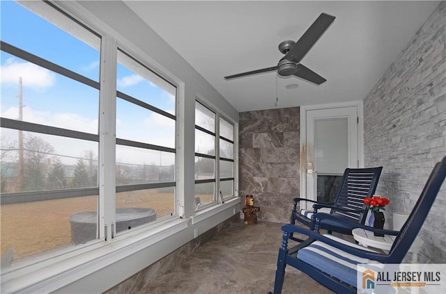 sunroom / solarium with ceiling fan