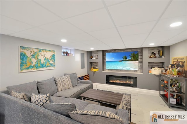 living room featuring a paneled ceiling