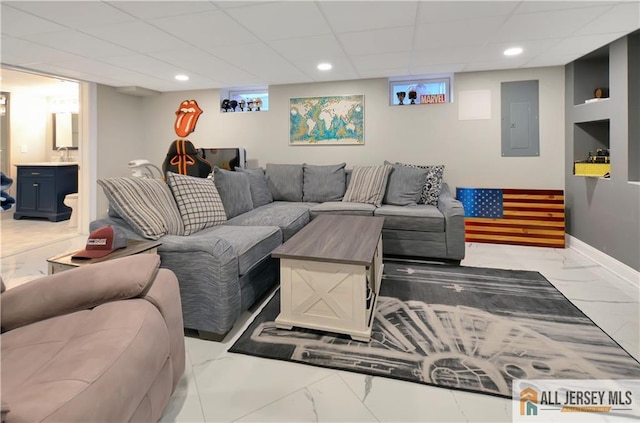 living room featuring a paneled ceiling and electric panel