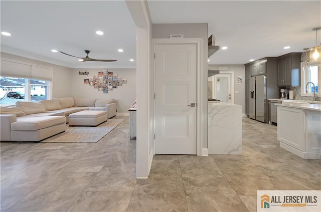 living room featuring sink and ceiling fan