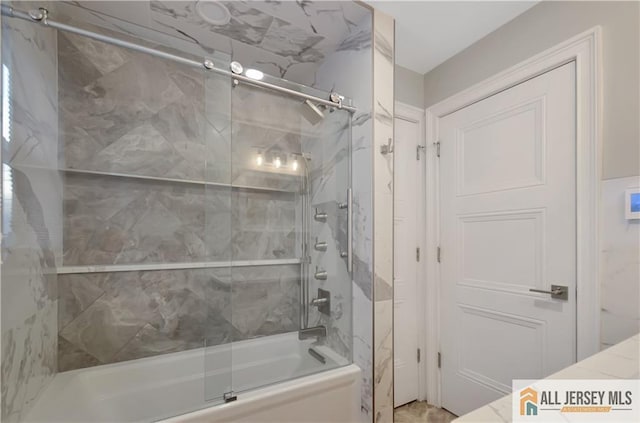 bathroom with shower / bath combination with glass door