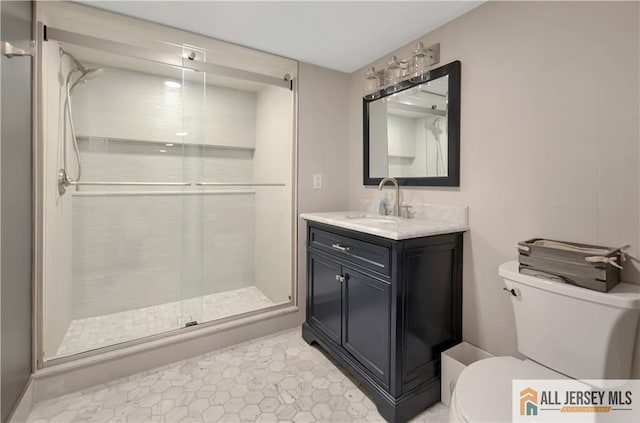 bathroom featuring vanity, toilet, and walk in shower