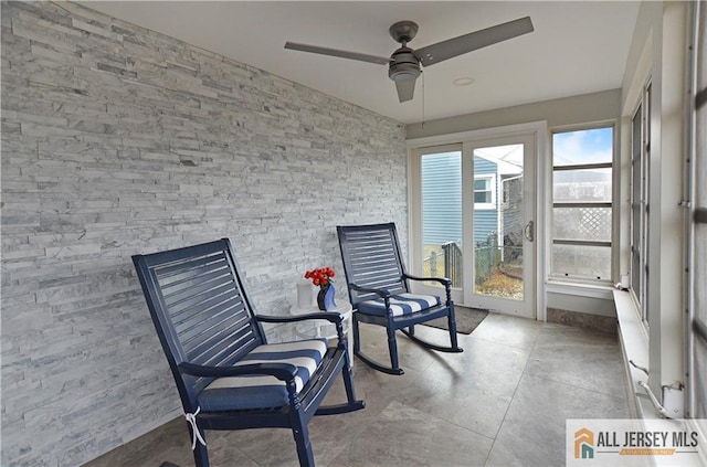 sunroom featuring ceiling fan