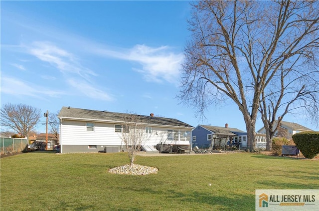 rear view of property with a yard