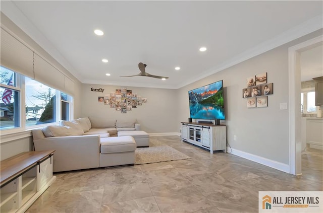 living room featuring ceiling fan and ornamental molding