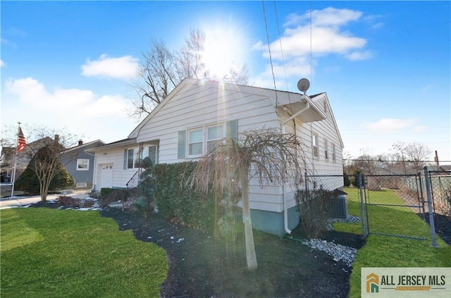 exterior space featuring cooling unit and a front yard