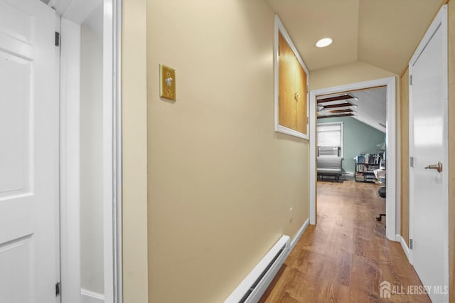 hall with recessed lighting, baseboards, wood finished floors, and lofted ceiling
