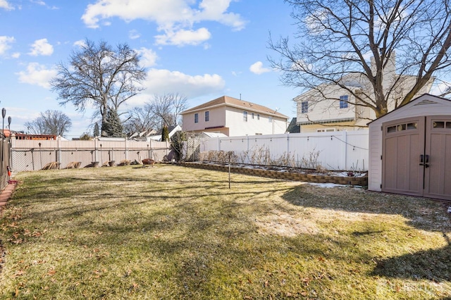 view of yard featuring a storage shed, an outbuilding, and a fenced backyard
