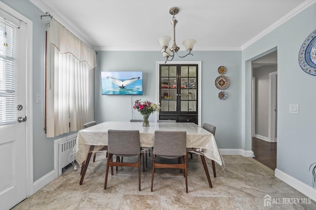 dining space featuring crown molding, baseboards, radiator, and a notable chandelier