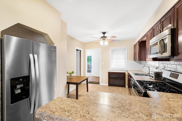 2903 Grasselli Ave, Linden, NJ 07036 - kitchen featuring stainless steel appliances, a sink, dark brown cabinets, light wood finished floors, and light countertops