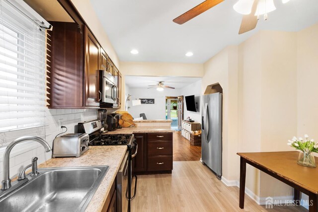 2903 Grasselli Ave, Linden, NJ 07036 - kitchen featuring stainless steel appliances, a ceiling fan, a sink, light wood-style floors, and light countertops