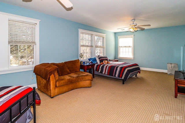 carpeted bedroom featuring a ceiling fan and baseboards