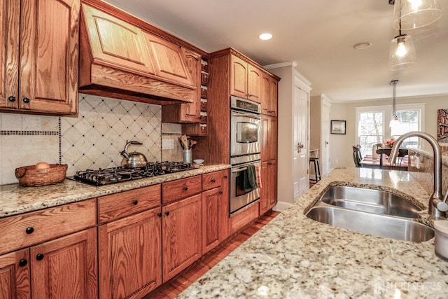 kitchen with stainless steel double oven, custom exhaust hood, gas stovetop, a sink, and tasteful backsplash