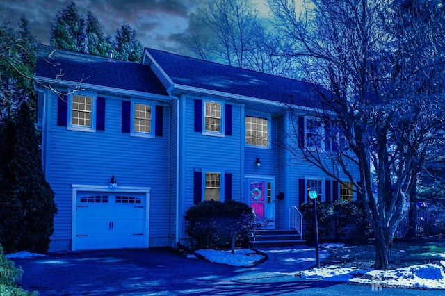 colonial home with a garage and driveway