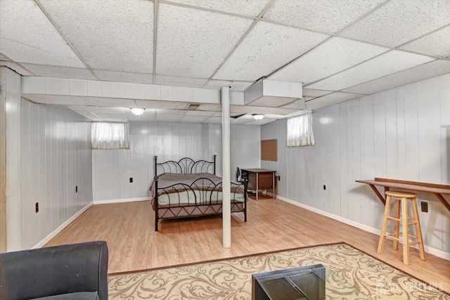 bedroom featuring a paneled ceiling and hardwood / wood-style floors