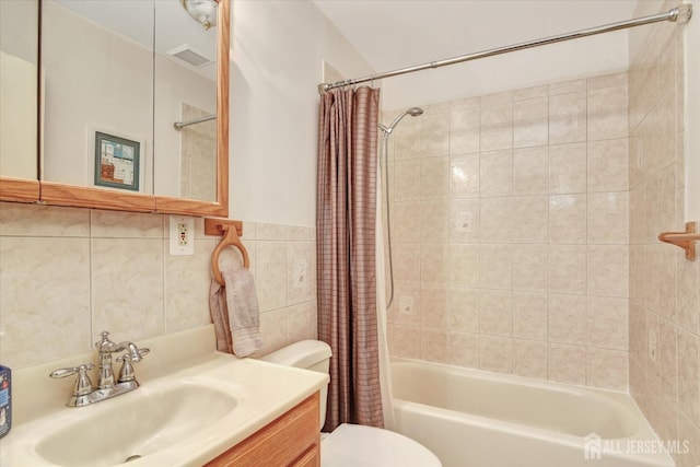 full bathroom featuring vanity, toilet, tile walls, and shower / bathtub combination with curtain