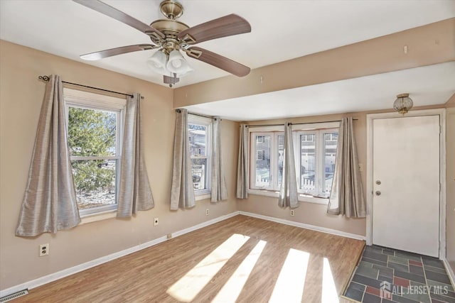 entrance foyer with dark hardwood / wood-style flooring and ceiling fan