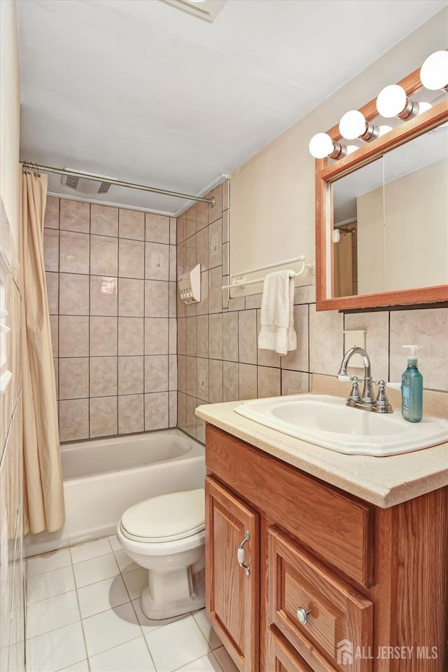 full bathroom featuring tile patterned floors, toilet, shower / tub combo, tile walls, and vanity