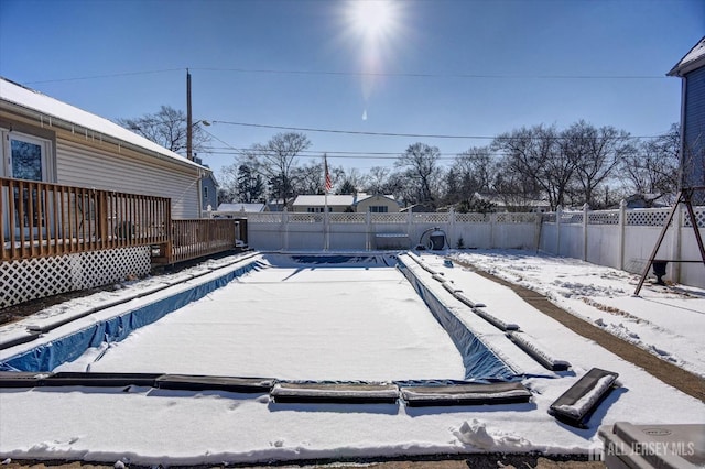 snow covered pool with a wooden deck