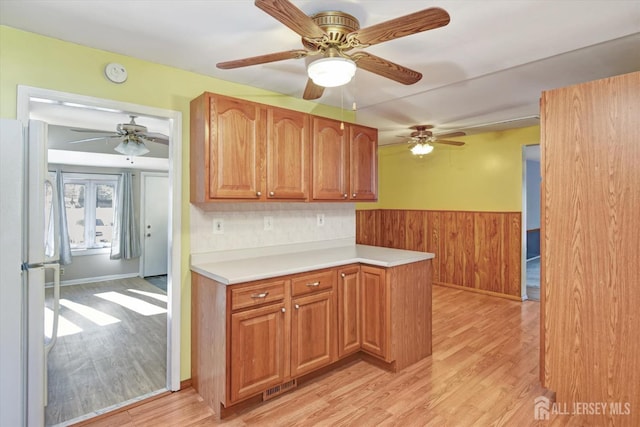 kitchen featuring light hardwood / wood-style flooring and white refrigerator