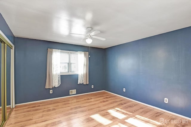 empty room featuring ceiling fan and light wood-type flooring