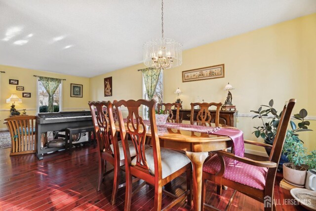 dining room featuring a notable chandelier and dark hardwood / wood-style flooring