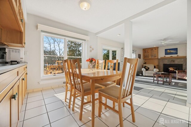 tiled dining area with ceiling fan