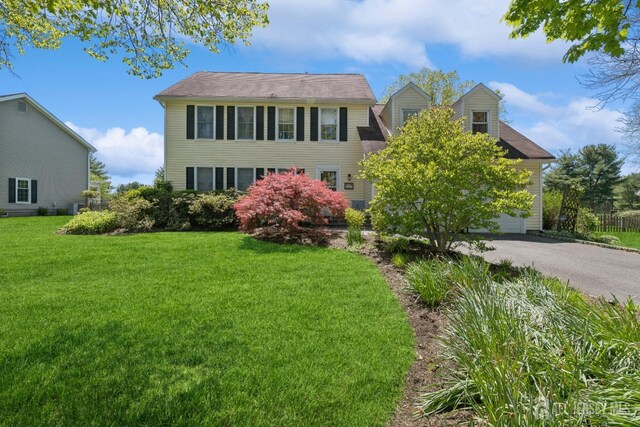 view of front facade with a garage and a front lawn