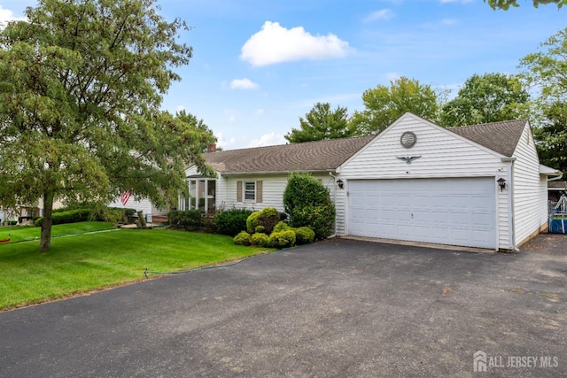 ranch-style house with a front yard and a garage