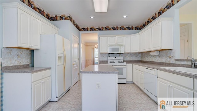532 Waterside Blvd, Monroe, NJ 08831 - kitchen featuring white appliances, a sink, a kitchen island, white cabinets, and light tile patterned floors
